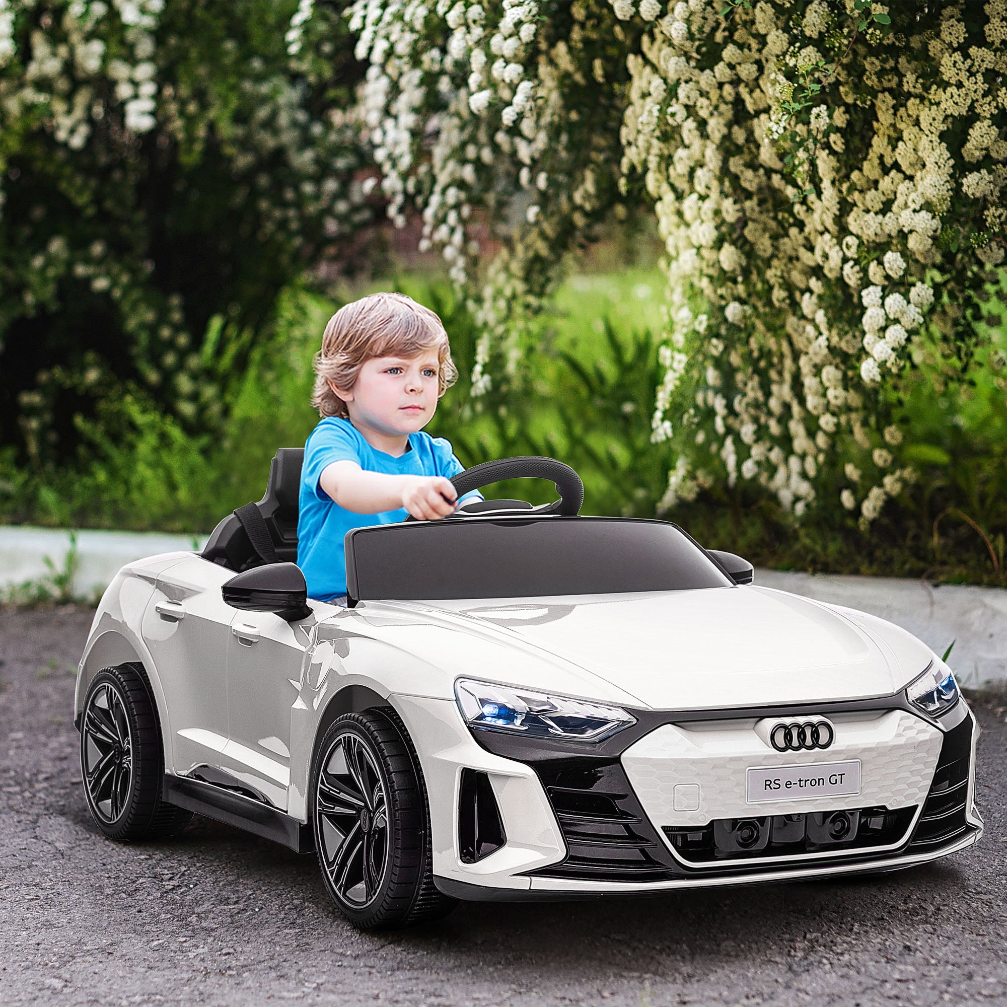 AUDI ELECTRIC CAR FOR KIDS YOUNG BOY RIDING HIS ELECTRIC CAR IN THE DRIVEWAY FOR CHRISTMAS