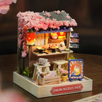 Miniature Sakura Noodles Shop model with cherry blossom decorations on a dark background
