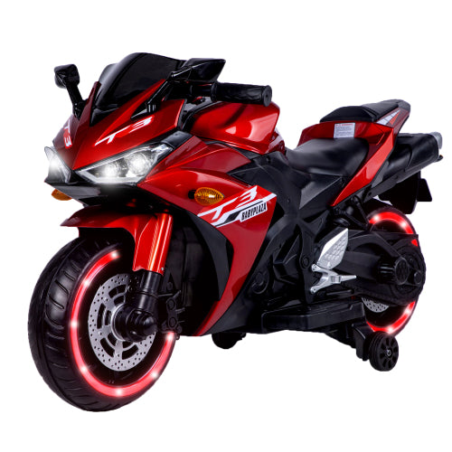 Red and black toy motorcycle with illuminated wheels on a white background