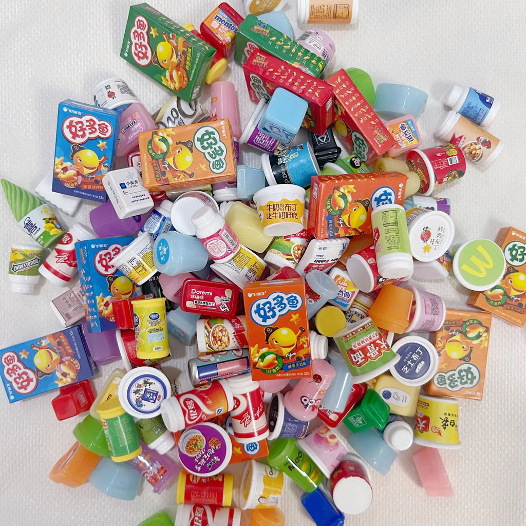 Assorted miniature food packages on a white background