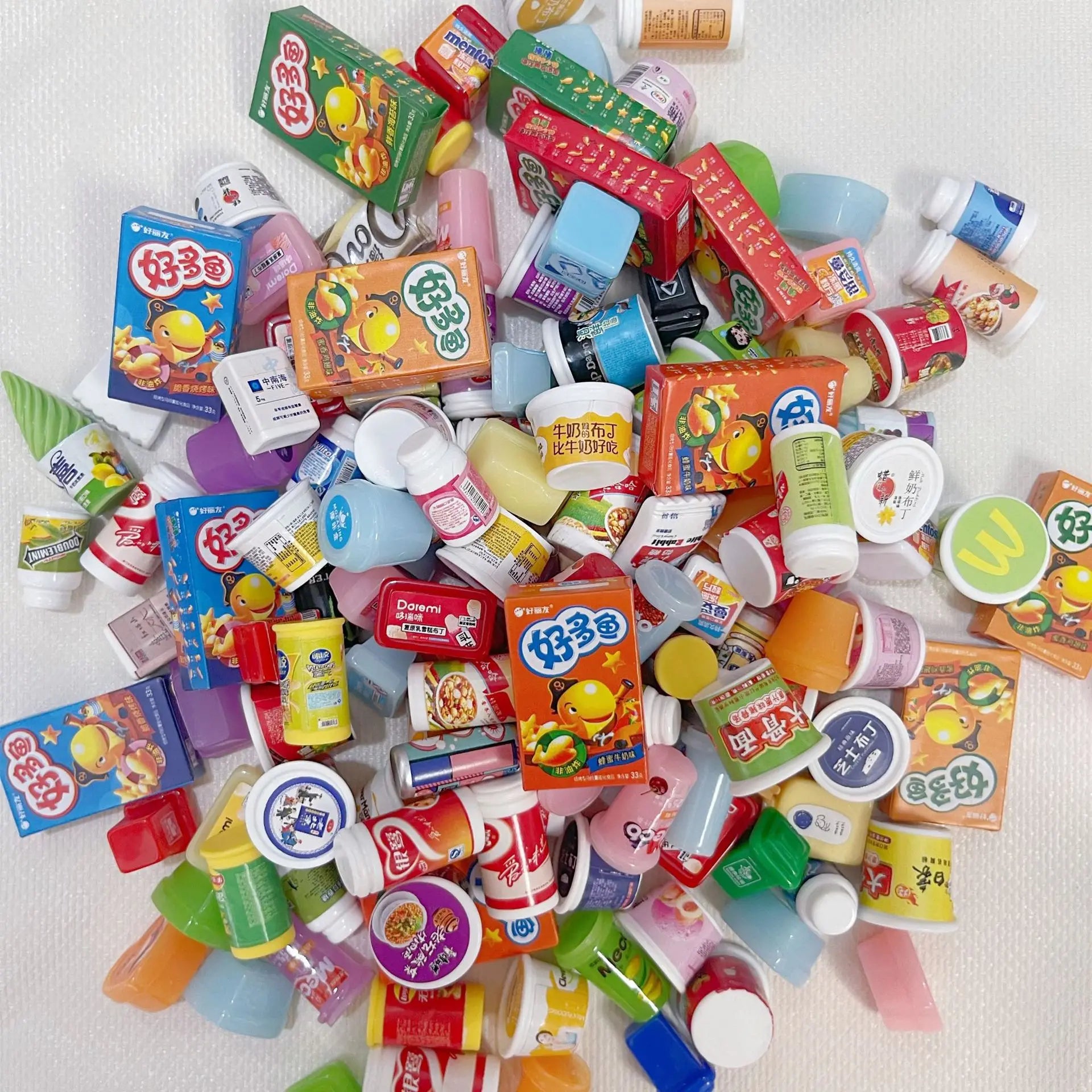 Assorted miniature food packages on a white background