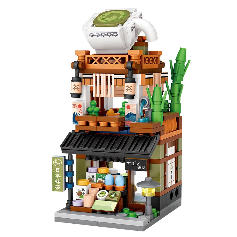 Toy building set resembling a tea shop with a teapot on top, on a white background