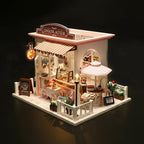 Miniature chocolate shop model with detailed interior and dimensions indicated.