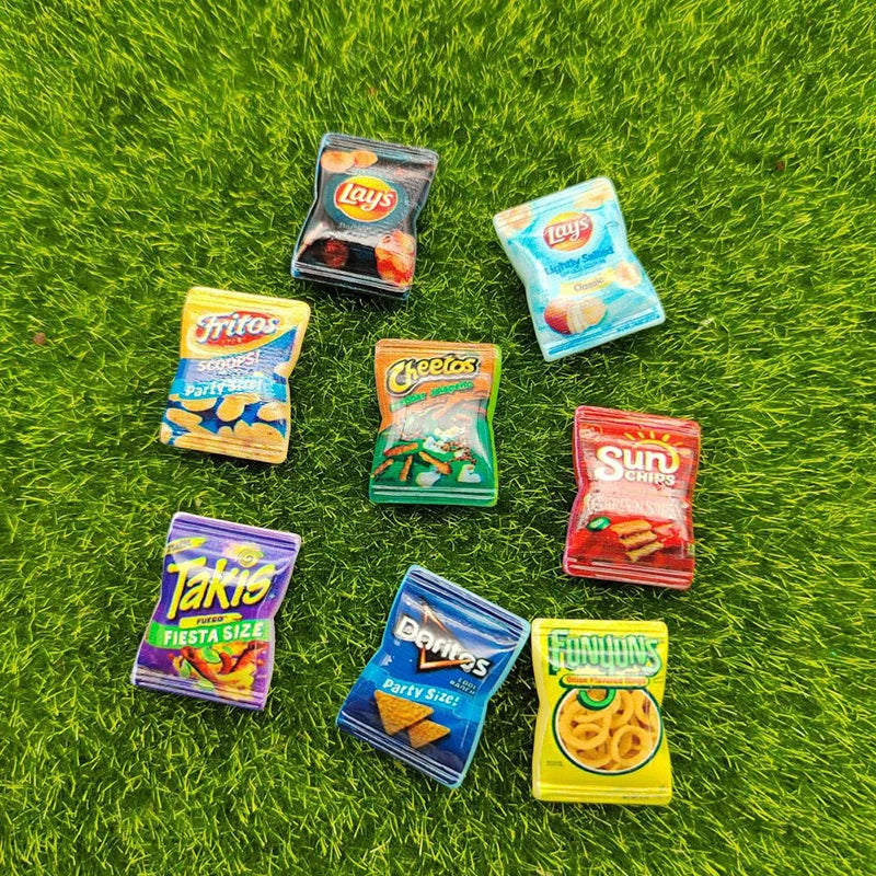 Miniature snack packs from various brands on a grassy background