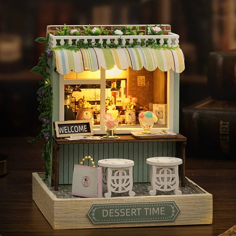 Miniature dessert stand with plants and a 'DESSERT TIME' sign on a wooden base.