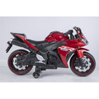 Red and black toy motorcycle on a light gray background