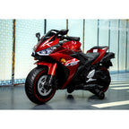 Red motorcycle on a reflective floor with a light blue wall background