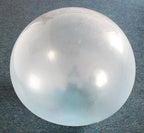 Clear plastic sphere on a gray background