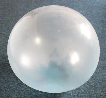 Clear plastic sphere on a gray background