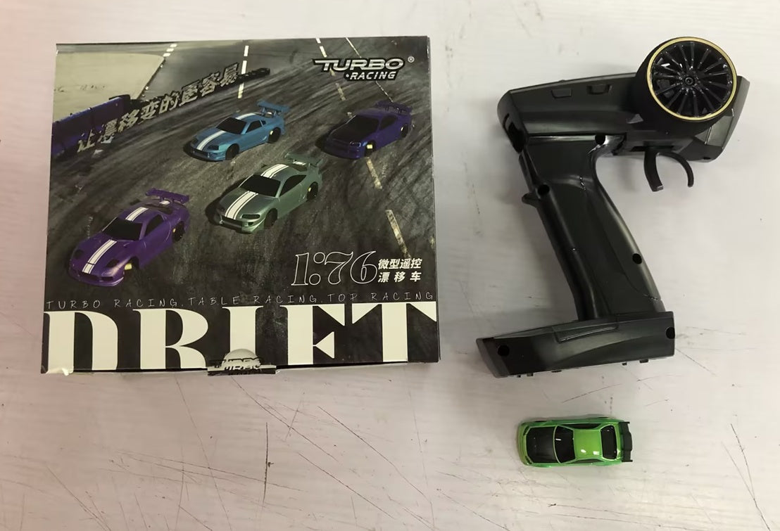 Toy car set with remote control and packaging on a white surface