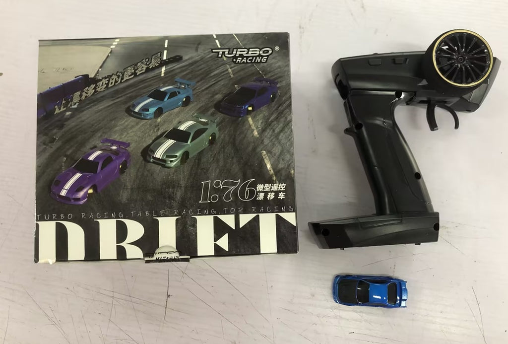 Toy drift car set with remote control and packaging on a white surface
