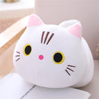 Plush cat toy with pink ears and black eyes on a light surface