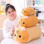 Person with a stack of cat-shaped plush toys on a table