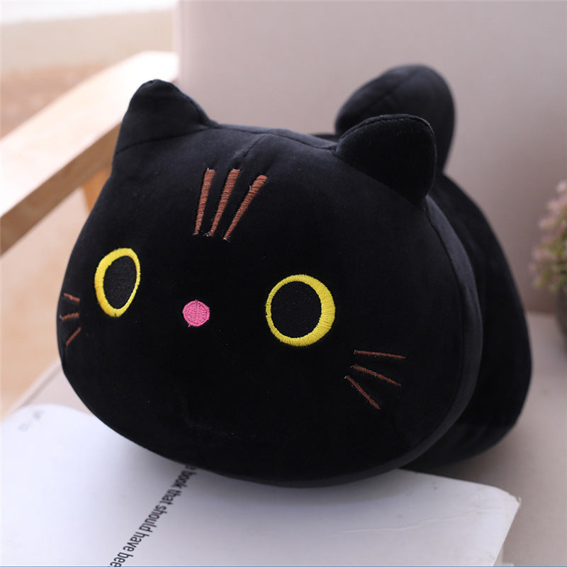 Black cat-shaped plush toy on an open book