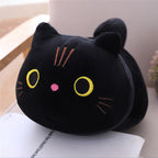 Black cat-shaped plush toy on an open book
