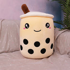 Cute plush toy resembling a bubble tea cup on a bed