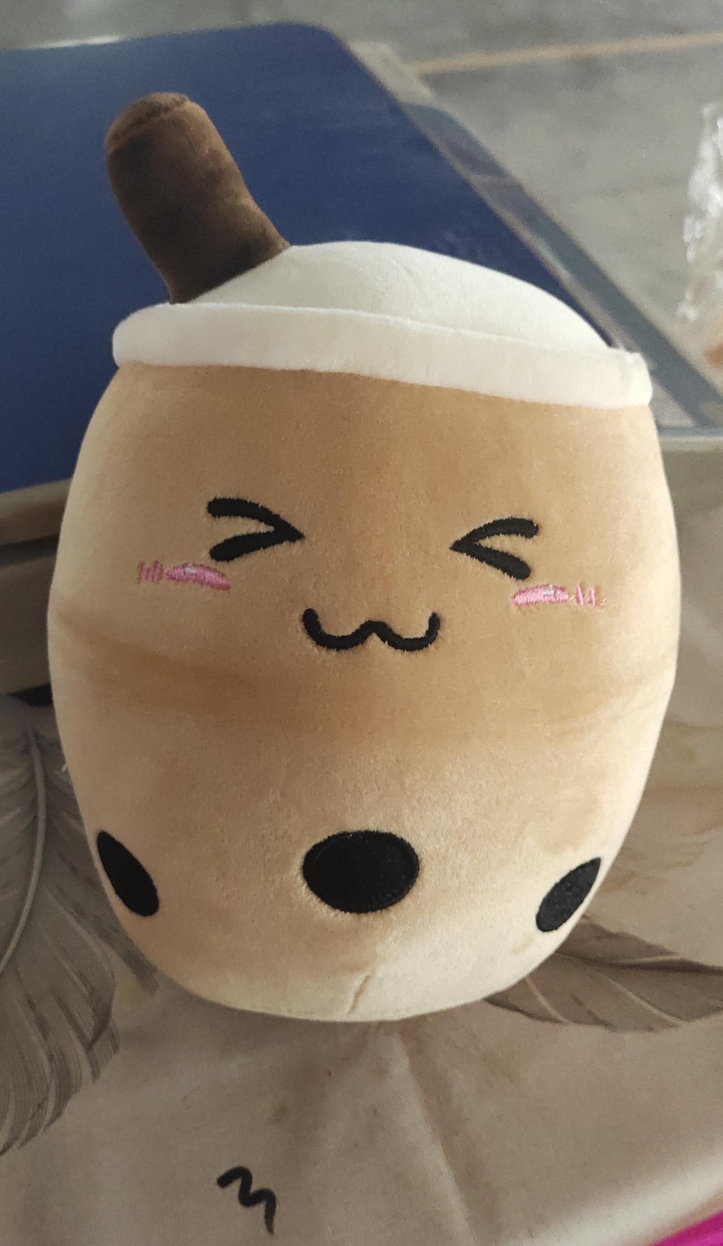 Plush toy resembling a cartoon character with a simple face design on a neutral background