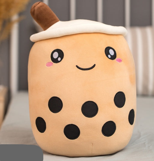 Plush toy shaped like a bubble tea cup with a smiling face on a neutral background