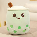 Plush toy resembling a green dessert with a smiling face on a beige background