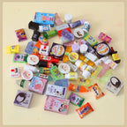 Collection of small containers and packaging on a beige background