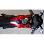 Close-up of a red and black motorcycle on a gray surface