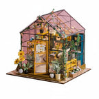 Miniature model of a greenhouse with plants and dimensions indicated