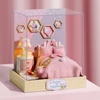 Pink dollhouse with furniture and decor in a clear display case on a pink background